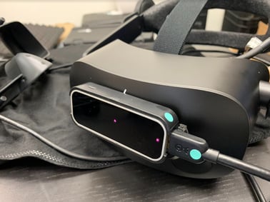 Leap Motion Controller mounted to the front of a black VR headset